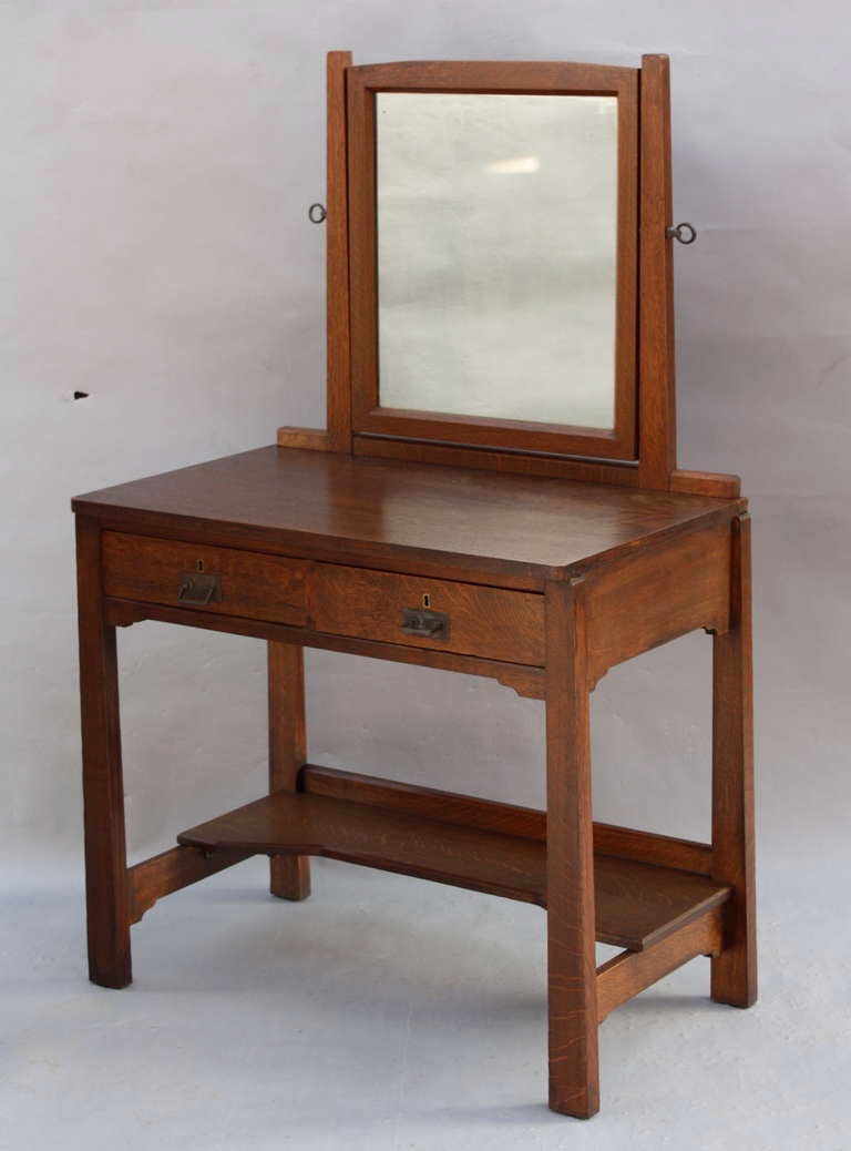 Beautiful in its simple and elegant design, this original oak dressing table c. 1910 has two drawers and a tilting mirror; wonderful clean lines are timeless and work with alongside almost any style