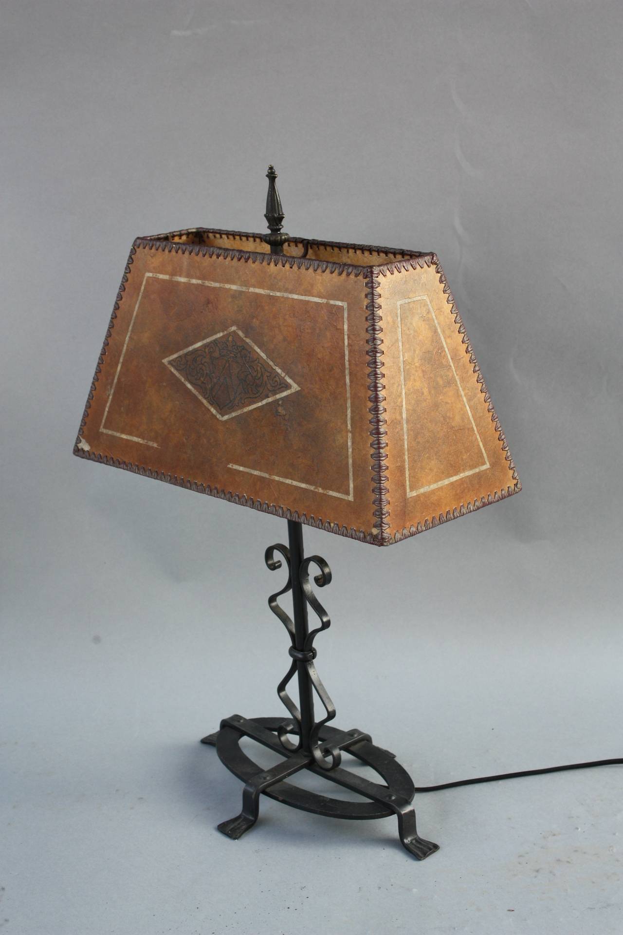 Circa 1920's table lamp with beautiful mica shade and interesting wrought iron base. 16
