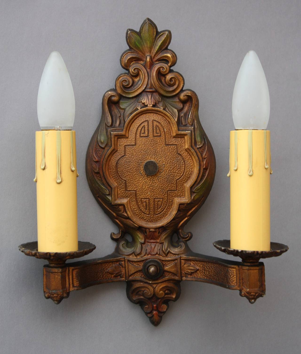 Pair of 1920's sconces with original hints of red and green polychrome finish. Measures 11