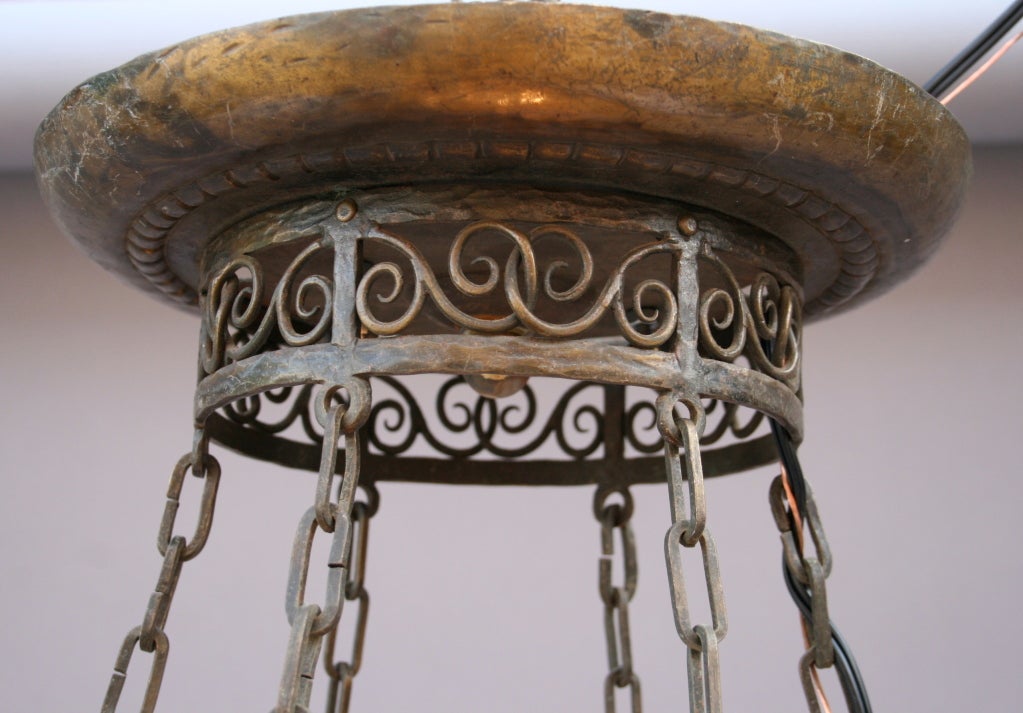 Absolutely beautiful iron bowl-like chandelier with all-over scroll and foliate designs lined in pale mica and dramatically suspended from original canopy by long chains.