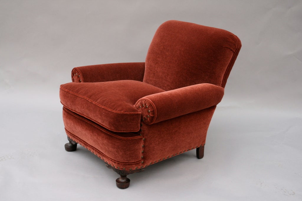 Extremely comfortable yet elegant classic '20's armchair recently upholstered in a rich, muted red upholstery accented with antique brass nailheads