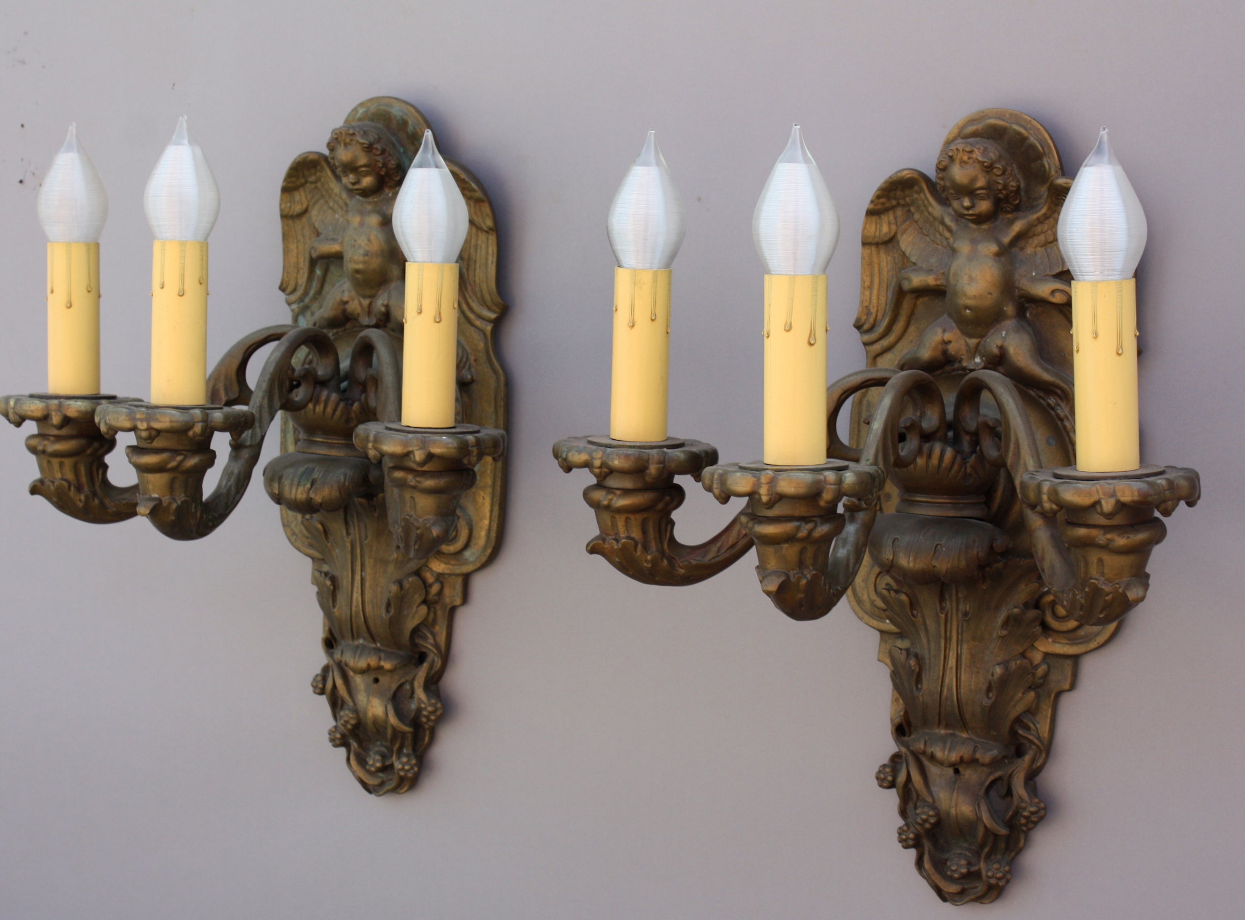 Pair of Bronze Sconces with Winged Cherubs and Acanthus Motif For Sale