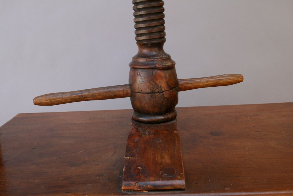 Beautiful antique bookbinding press with threaded wooden screw shaft.