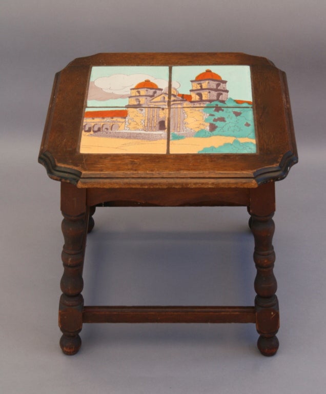 The picturesque Santa Barbara Mission is depicted on this colorful c. 1920's tile-topped table by Taylor Tilery of California.