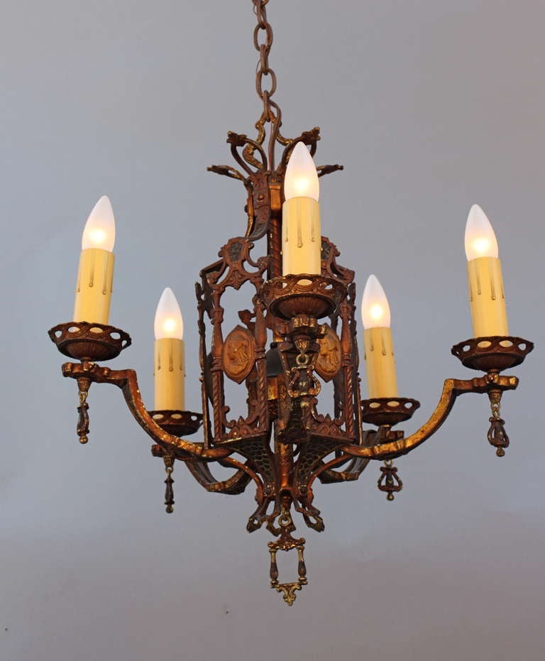 Circa 1920's chandelier with a classic Egyptian motif in lovely medallions. Original finish. Fixture itself is 20.75