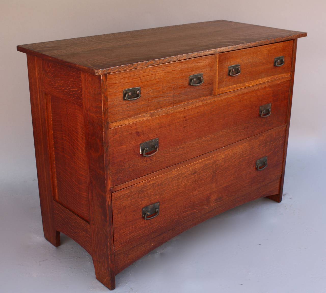 Classic Arts & Crafts chest featuring four drawers and original hardware. C. 1910. Arch front. Measures 48