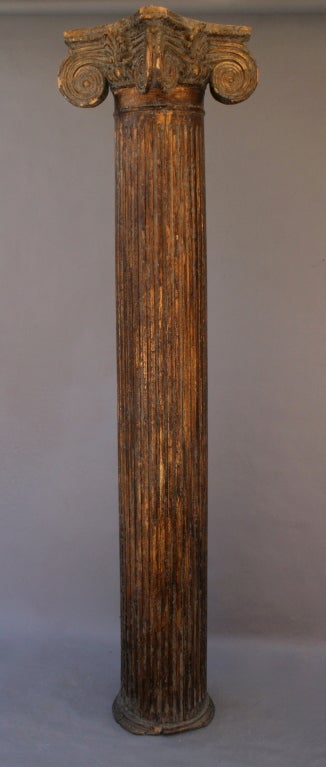 Tall and dramatic classical ionic column of gilded wood