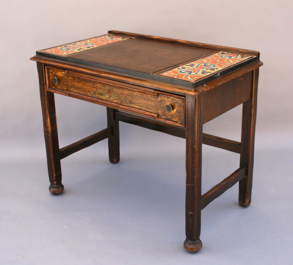 Charming mahogany desk/dressing table with colorful Tudor tile top surface and decorative hand painting on face of drawer