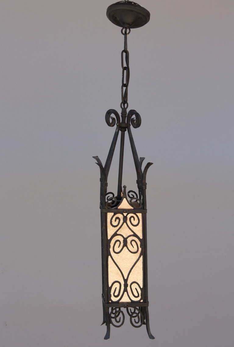 Narrow 1920's pendant with scroll work and replaced mica. Fixture itself is 24
