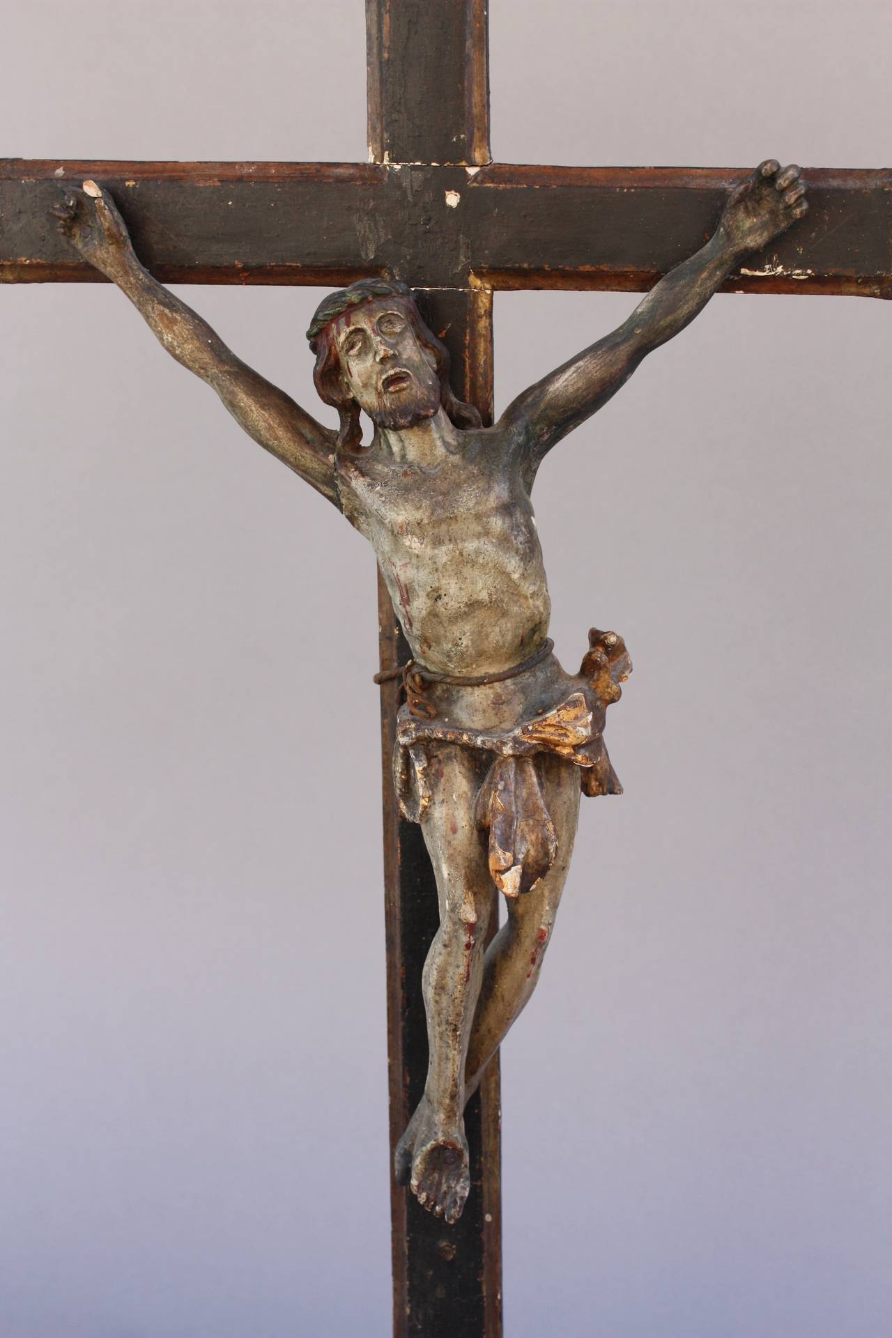 Finely carved crucifix with original painted and gilt finish. It measures 36 H x 6 D x 19 W