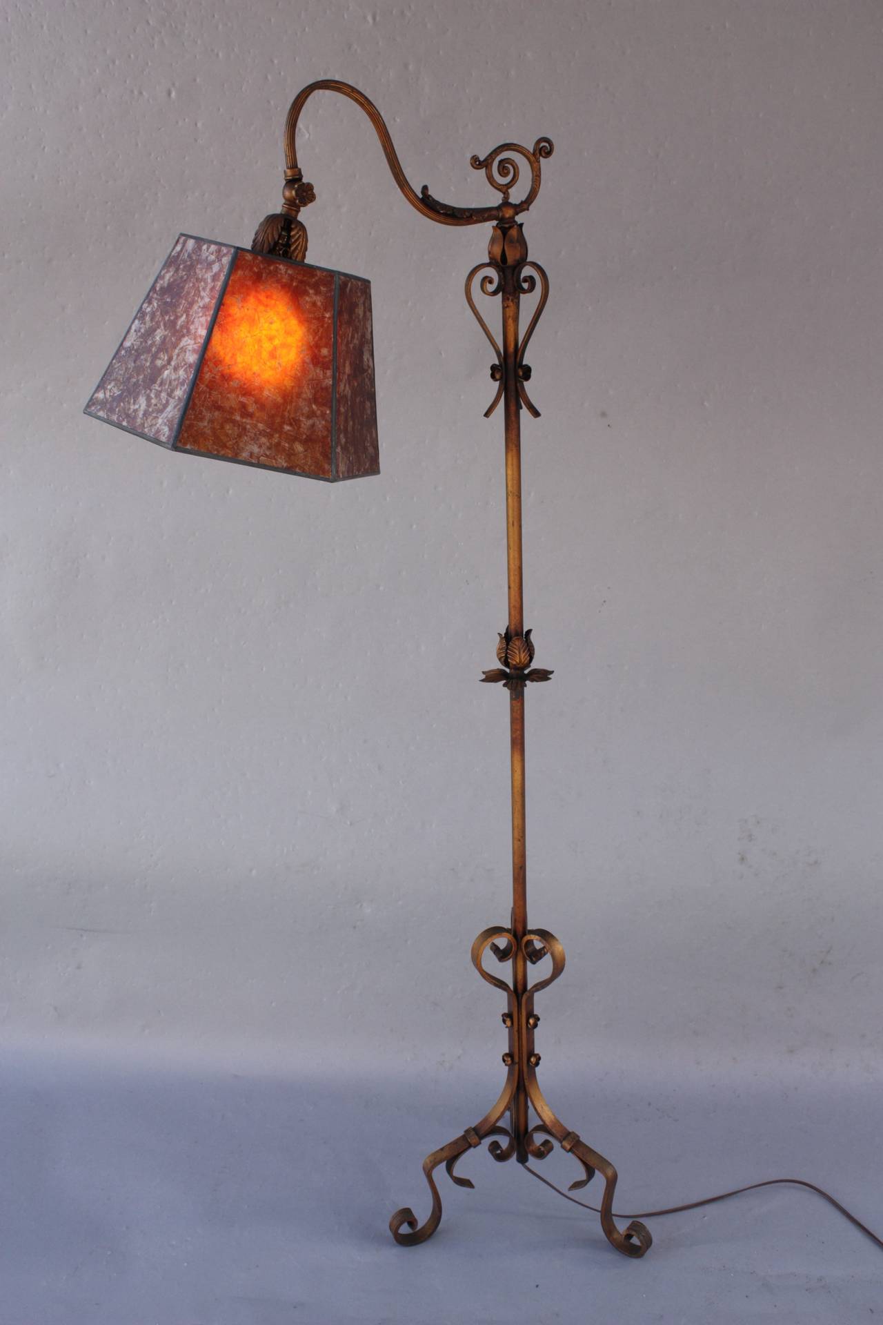 Circa 1930's floor lamp with wonderful base. The shade is a new mica shade. The lamp measures 57