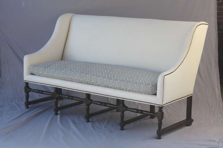 Circa 1940's walnut bench with new linen and Spanish pattern upholstery. 80