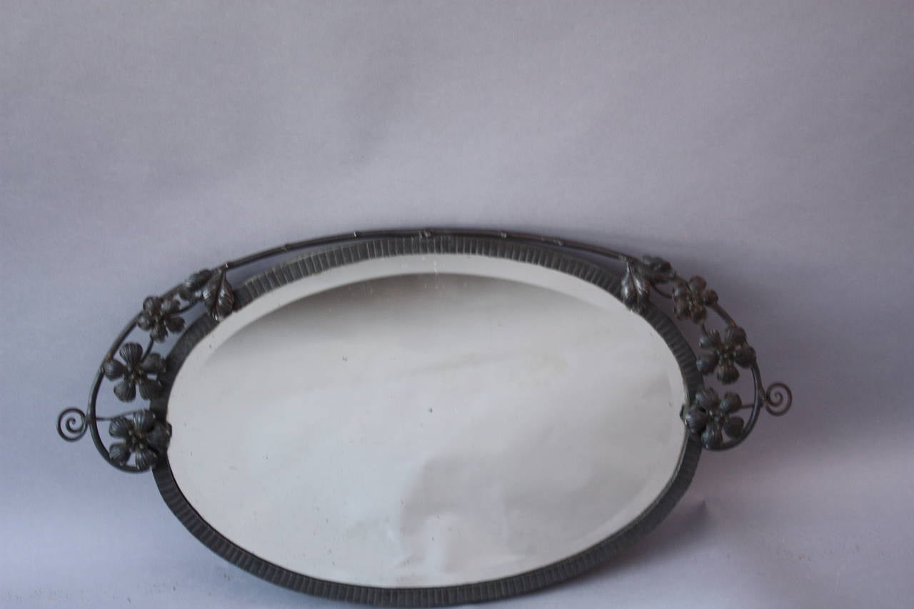 Very nicely crafted wrought iron mirror in difficult to find oval shape. Measures 14 3/4