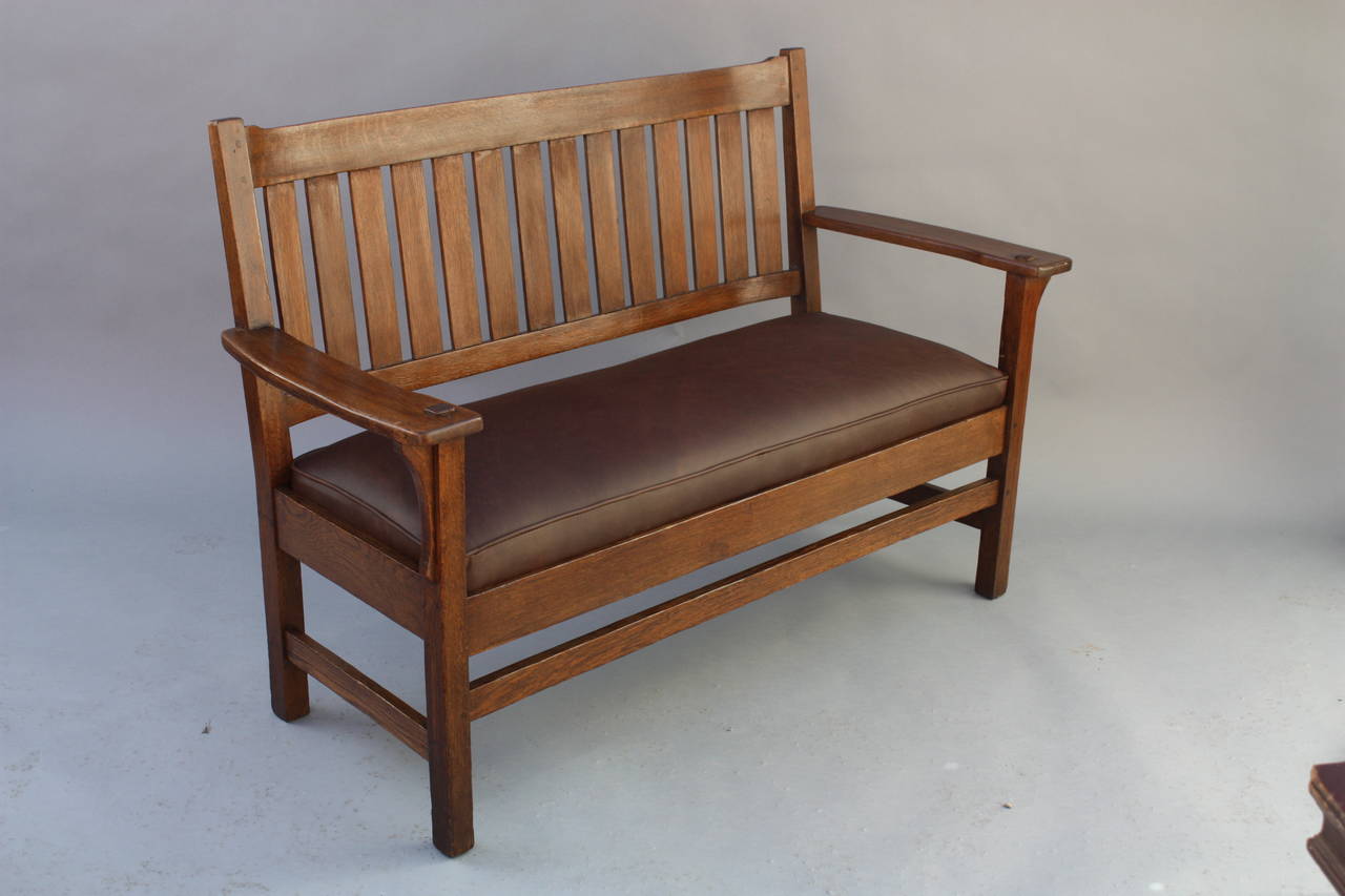 Circa 1910 arts and crafts settle with new leather upholstery. The piece is pinned. Quarter sawn oak. 55