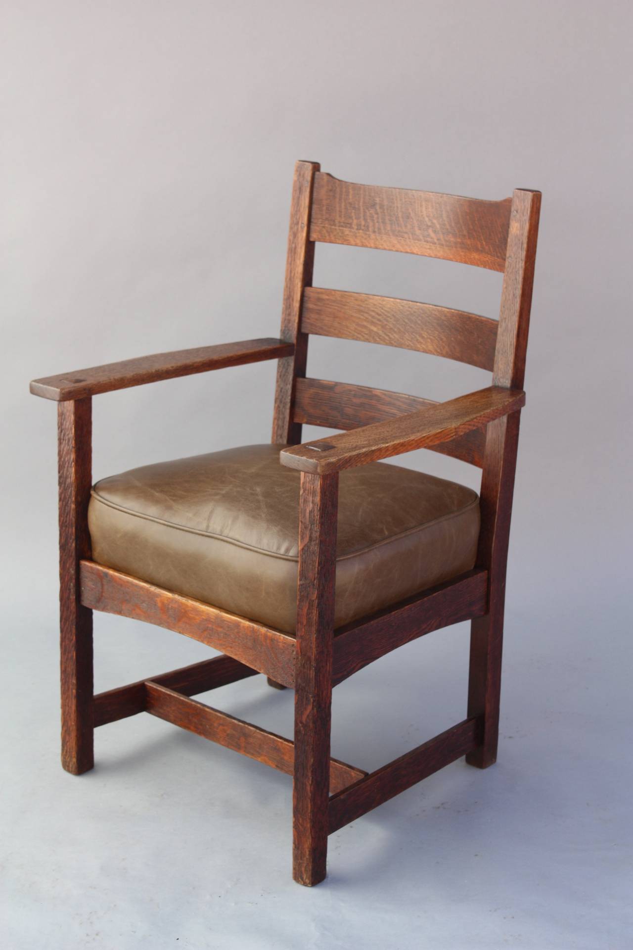 Circa 1910 arts and crafts armchair. New leather seat. Original finish. Quarter sawn oak. Signed. 38 1/8 
