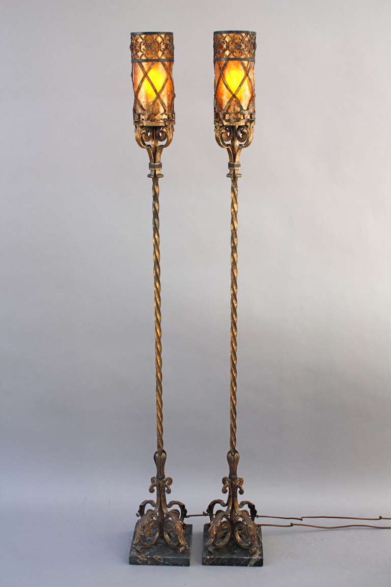 Imposing pair of torchieres with mica on marble base. This pair retains its original finish and represents the high craftsmanship of the Spanish Revival era.