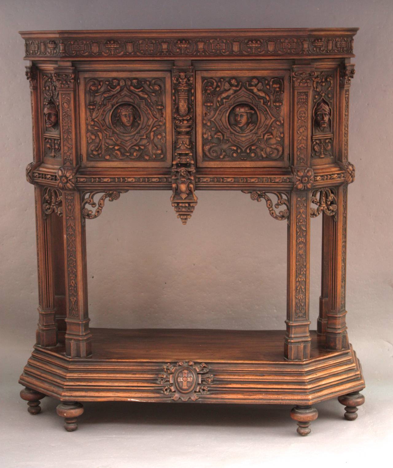 This magnificent cabinet comes from an important 1920’s estate in Montecito. The walnut  carving is of the highest quality. Walnut. It measures 65” H X 59.5L X 23.25” D