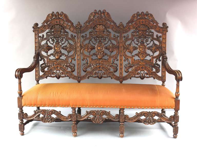 Highly carved Spanish Revival Bench with bird motif. Walnut. 73