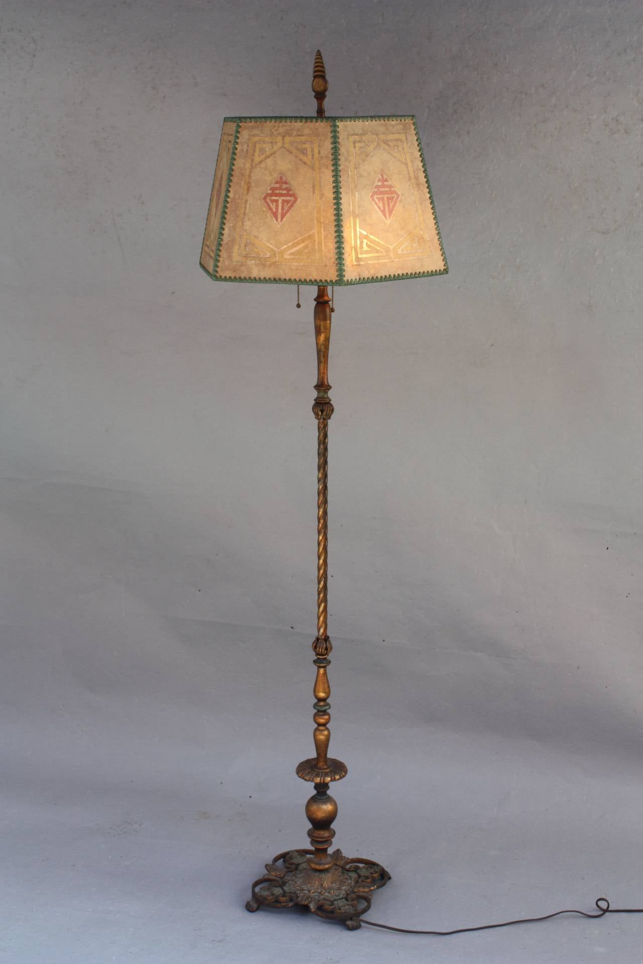 Circa 1920's lamp with original shade and base. Polychrome finish on base 12
