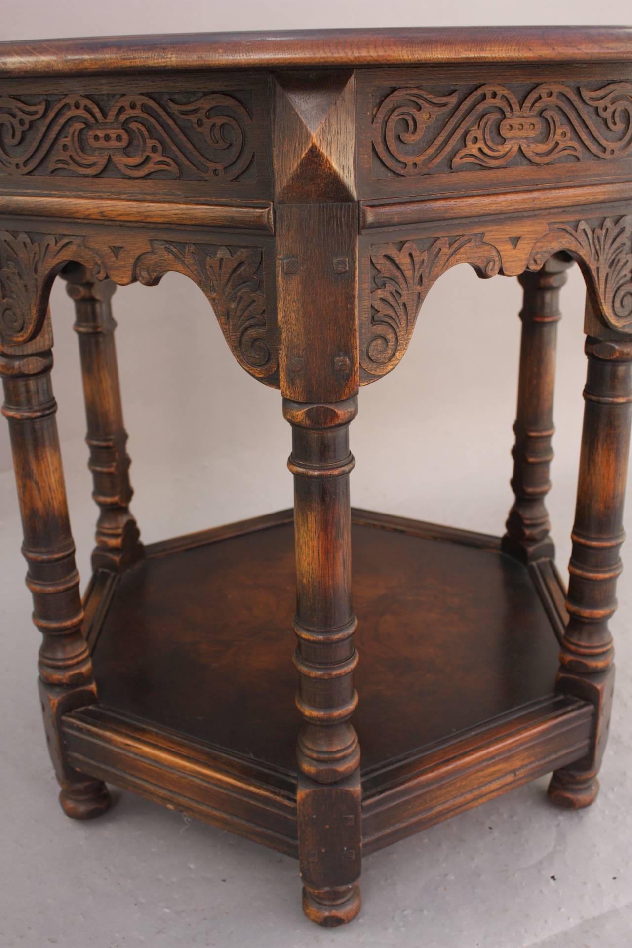 Circa 1920's carved walnut table with lower shelf. 29.5