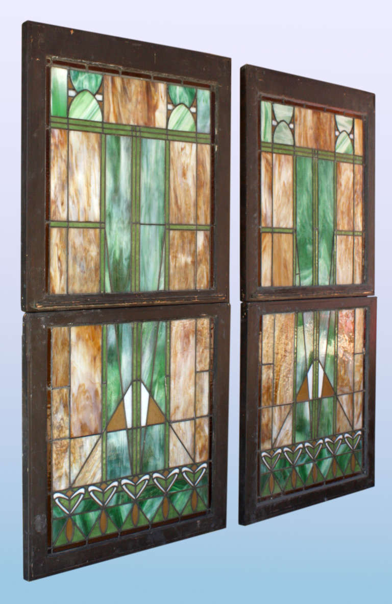 Will sell individually. Each window comprises two panels. Amazing Arts & Crafts-era Prairie School influenced window panels Circa 1910. Very classic and vibrant design from the period. A few tiny hair line cracks in the glass. Top panels measure 33