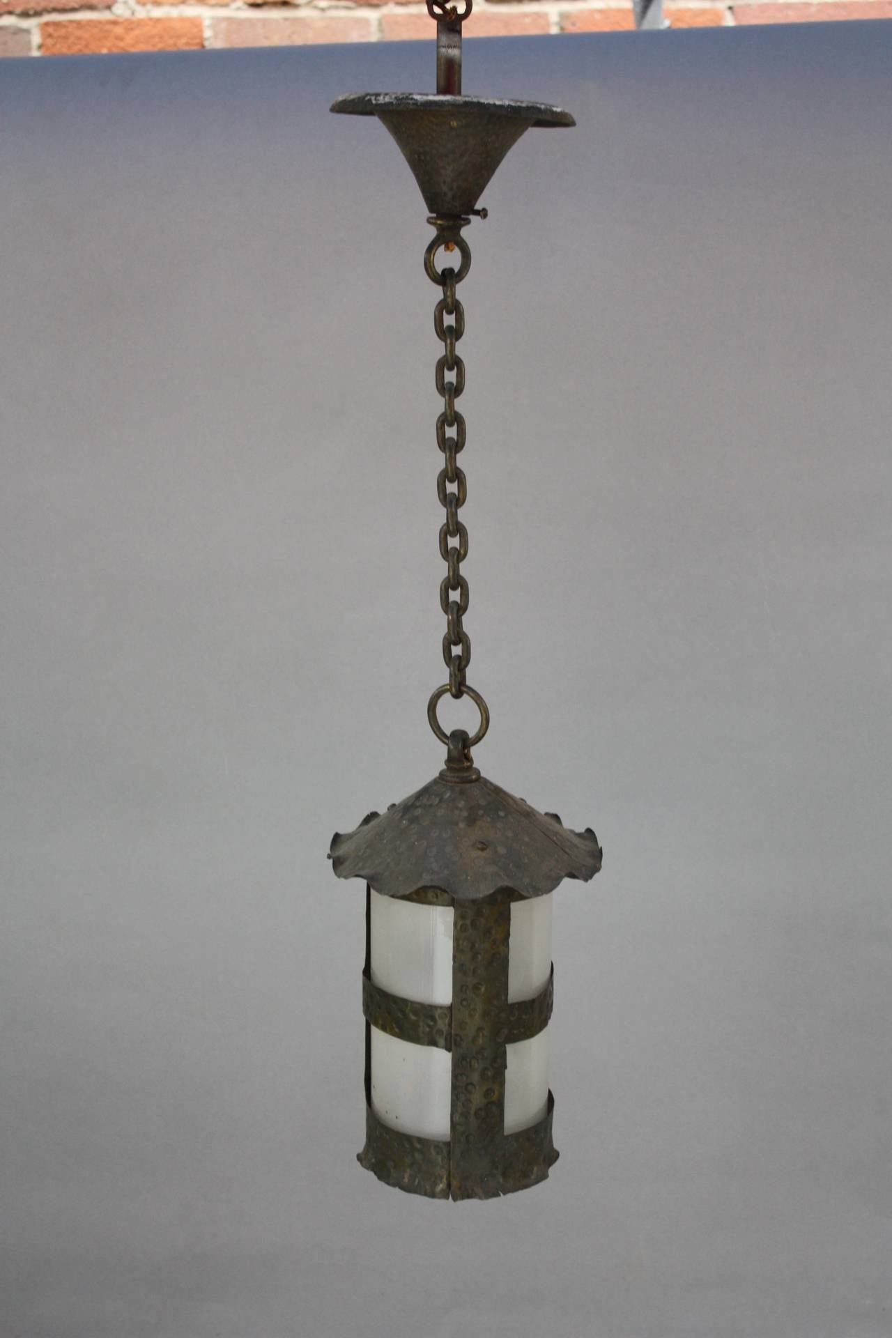 Classic hammered pendant with original glass insert. It measures 12 1/2” tall and 8” at its widest. 28 1/2” overall including the chain and canopy.