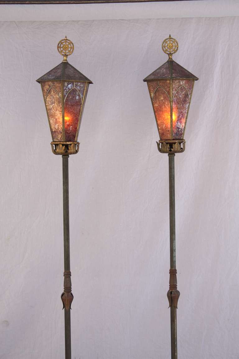 Circa 1920's torchieres with beautiful mica tops. Original finish. Brass, iron, bronze. Each torchiere measures 78