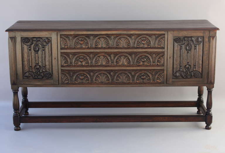 Classic Spanish Revival sideboard. Circa 1920s. Manufactured by the prestigious Marshall Laird Cie of Los Angeles. Carved oak cabinet. Measures 36 1/4