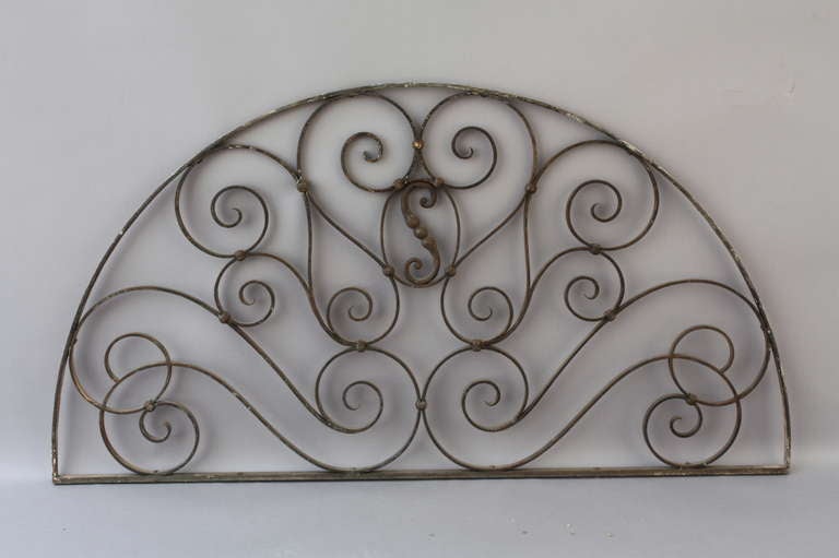 Large, elegant wrought iron arches c. 1900- 1920's from a grand Mediterranean estate in Pasadena, CA. These were most likely placed in open or glassed archways and are beautiful architectural works of art on their own. Priced and sold separately.