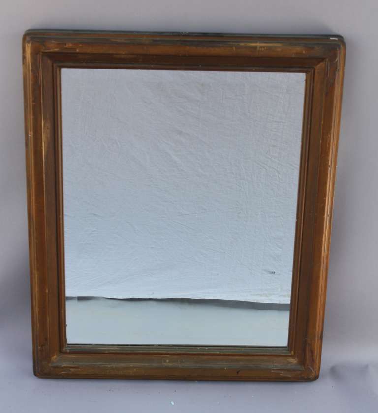Circa 1910 wood frame. American. Replaced mirror.