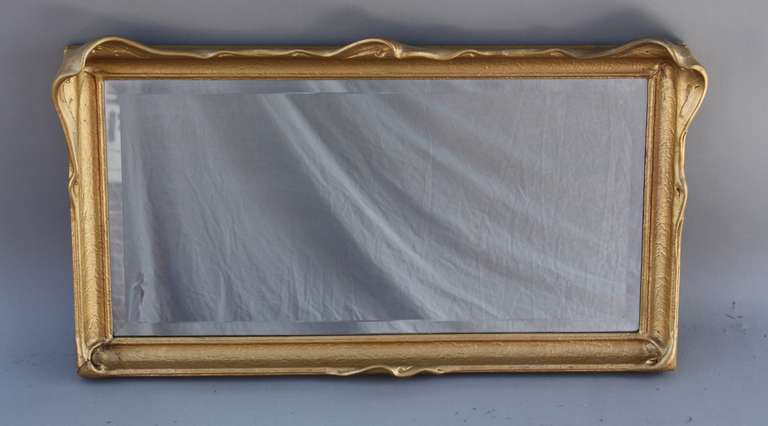 Circa 1910 mirror with beautiful wing bat frame. Replaced bevelled mirror.