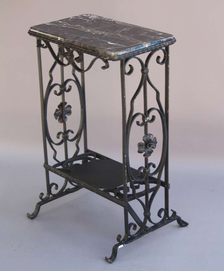 Circa 1920's table with marble top and iron lower shelf. 28.25