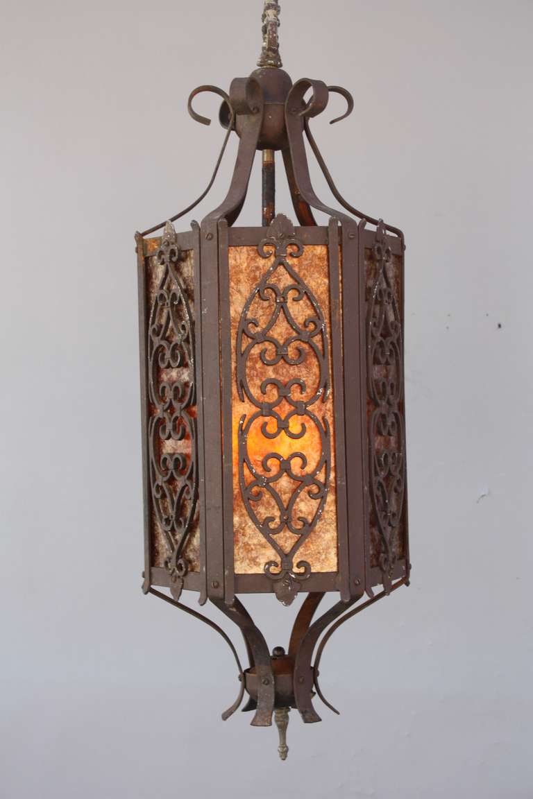 Circa 1920's Spanish Revival pendant with mica. Classic Spanish Revival scroll work, The body of the fixture is 37.5