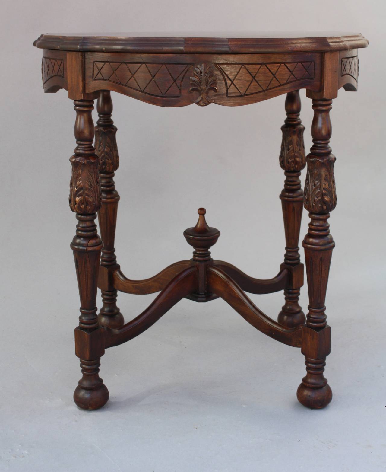 Circa 1920's carved walnut table with beautiful patterned top. 30.25