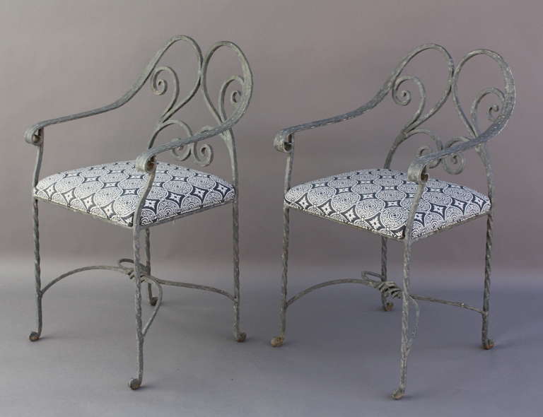 Circa 1920s. Elegant wrought iron frame with new outdoor fabric. Measures 34 1/4