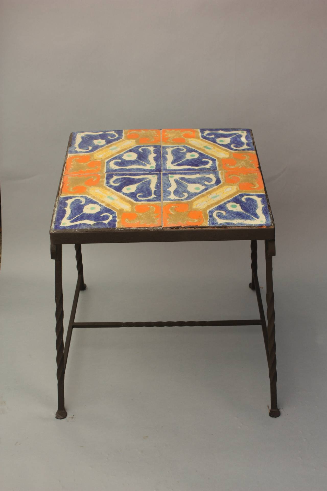 Circa 1930's iron tile table with vibrant D&M tiles. 19.25