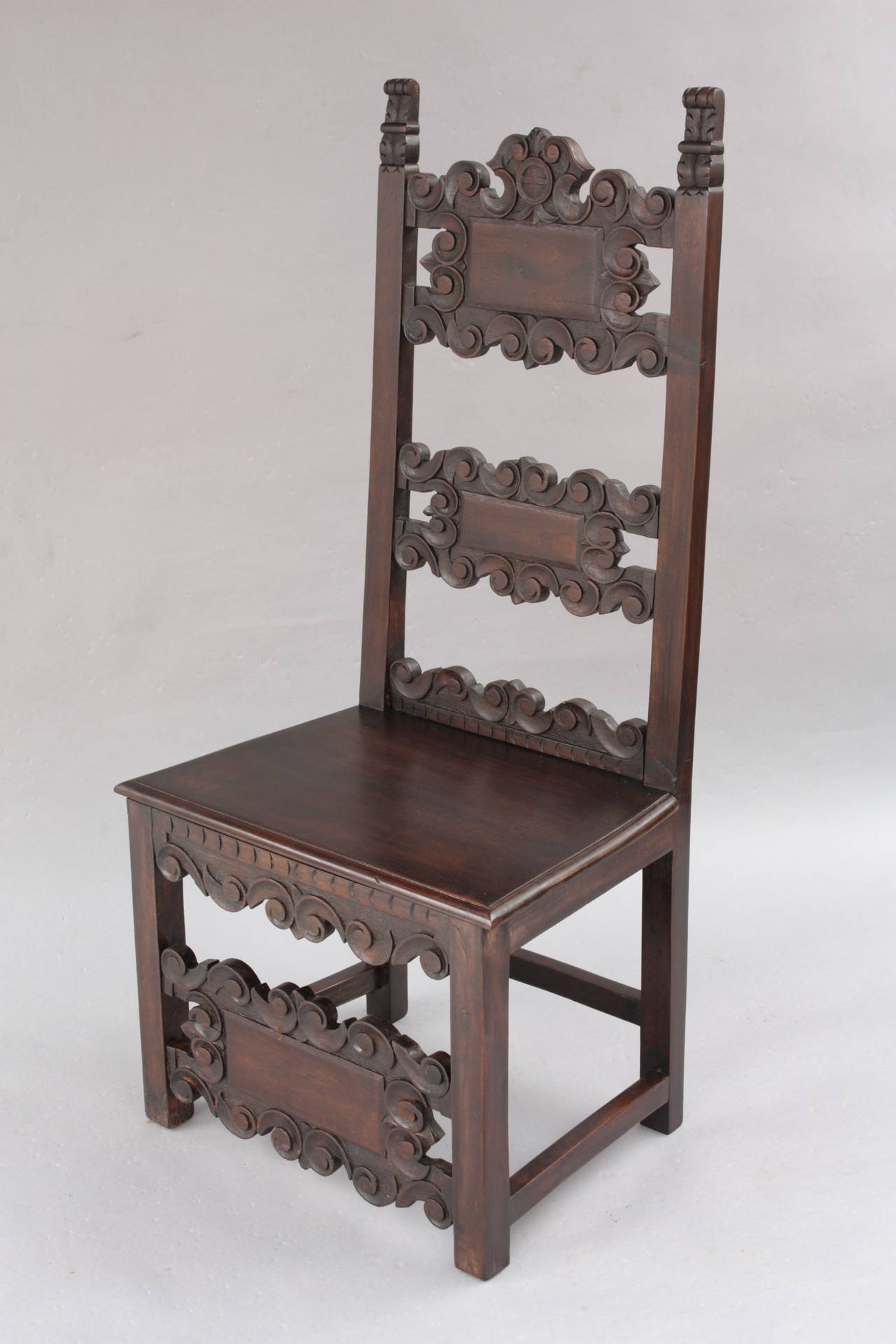 Circa 1920s carved set of four chairs. Three of the chairs have the same back railings and the other has a different back. 45.25