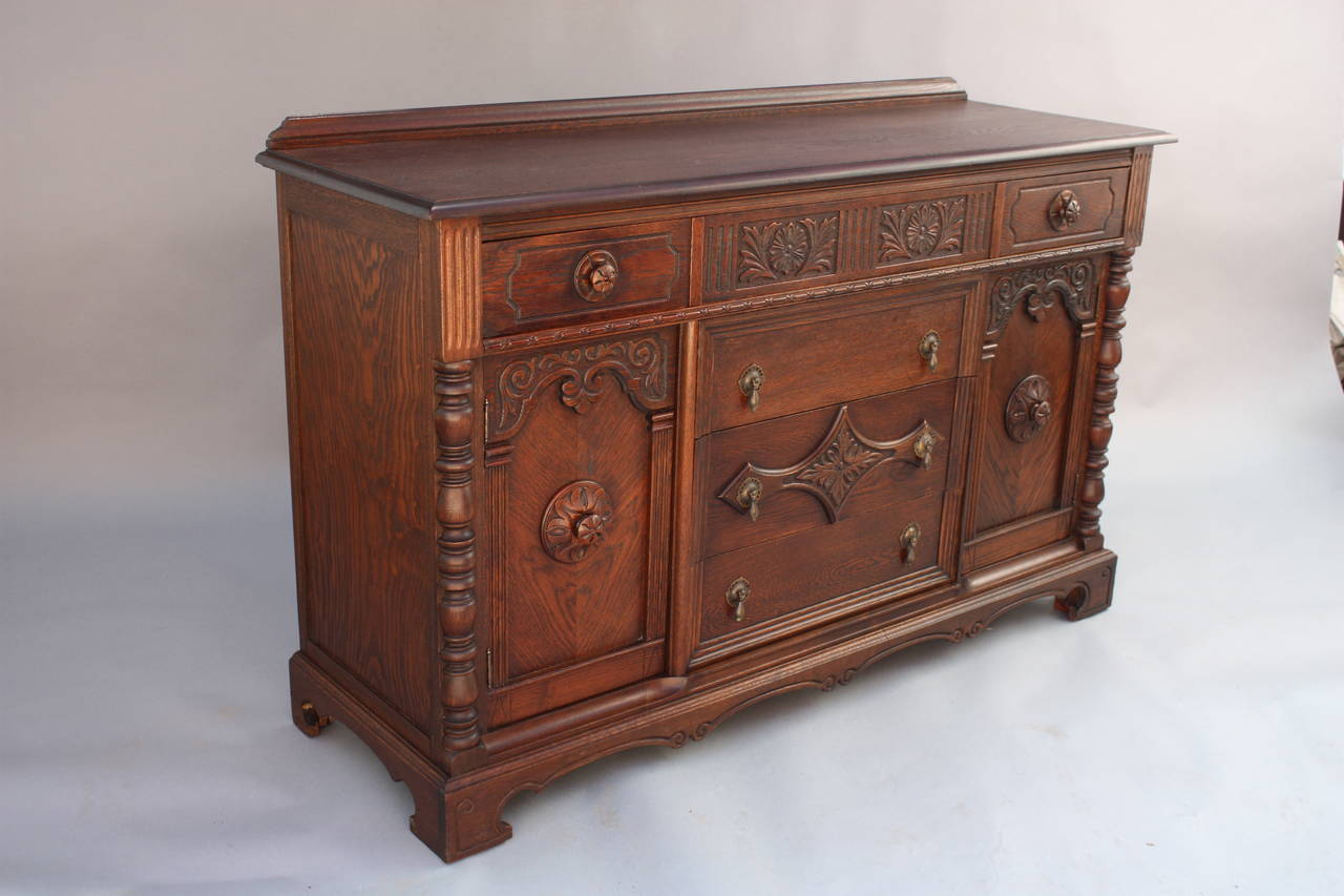Circa 1920s sideboard with lots of storage. Carved oak 38.75