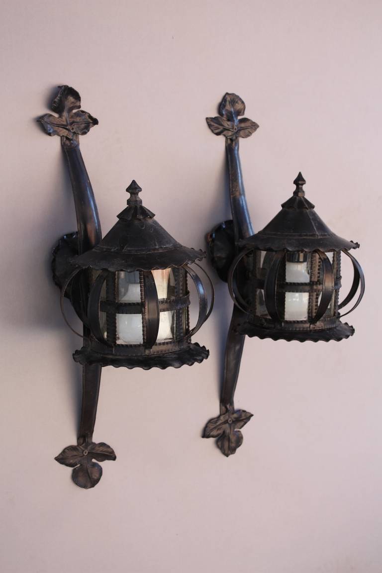 1920s hand-wrought pair of porch lights. Perfect for a Spanish Revival home offering fine craftsmanship and an elegant design.