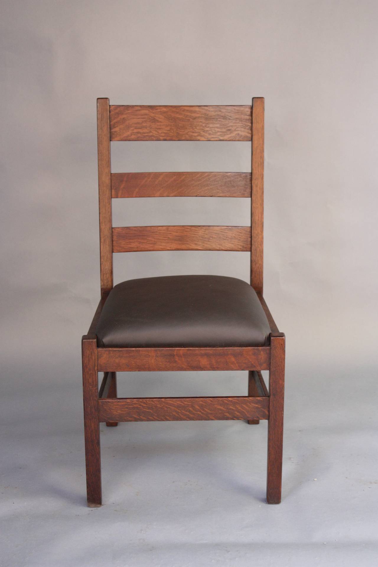 Circa 1910. The Stickley and Brandt Company was established by Charles Stickley and Schuler Brandt. This sturdy antique chair has new leather and the original label.