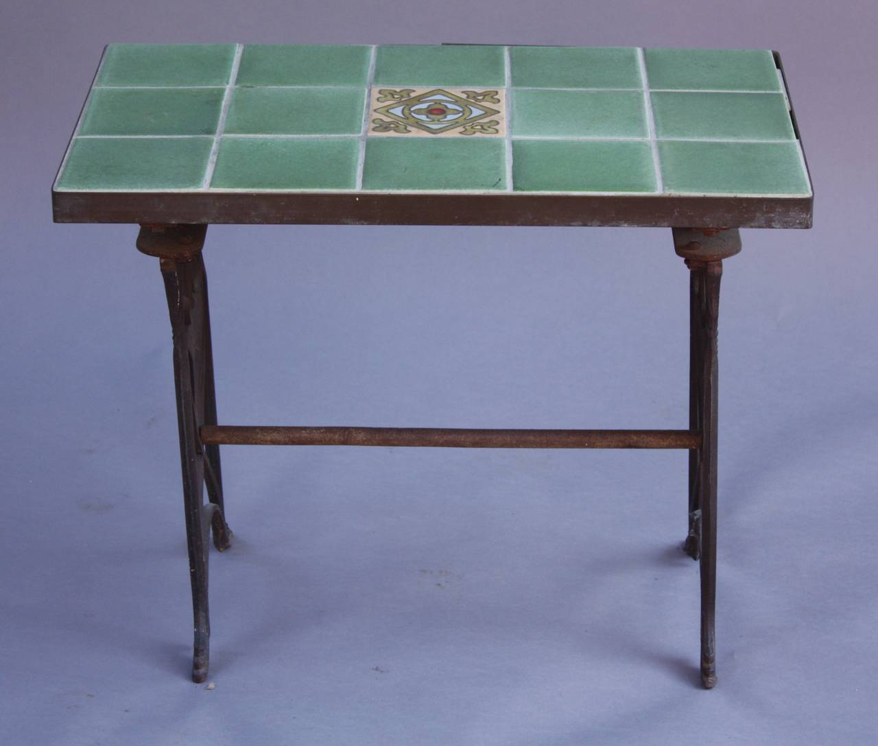 Circa 1920's rare tile table with polychrome crest motif on side and original period tiles.