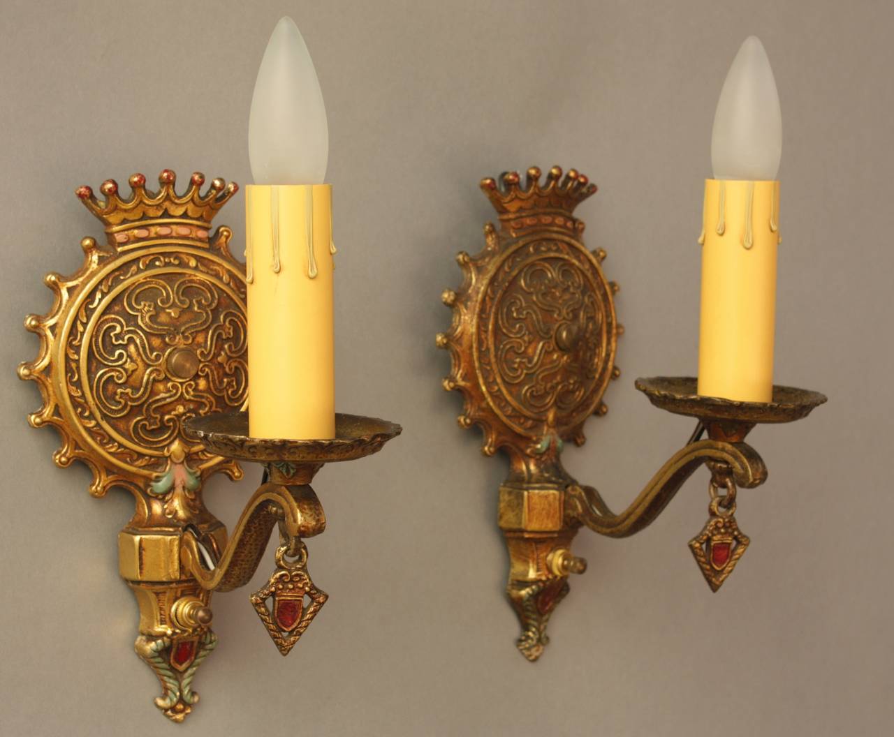 Ornately cast single light sconces with nice attention to detail. It features beautiful polychrome finish original to the sconces. Measures 5 1/4