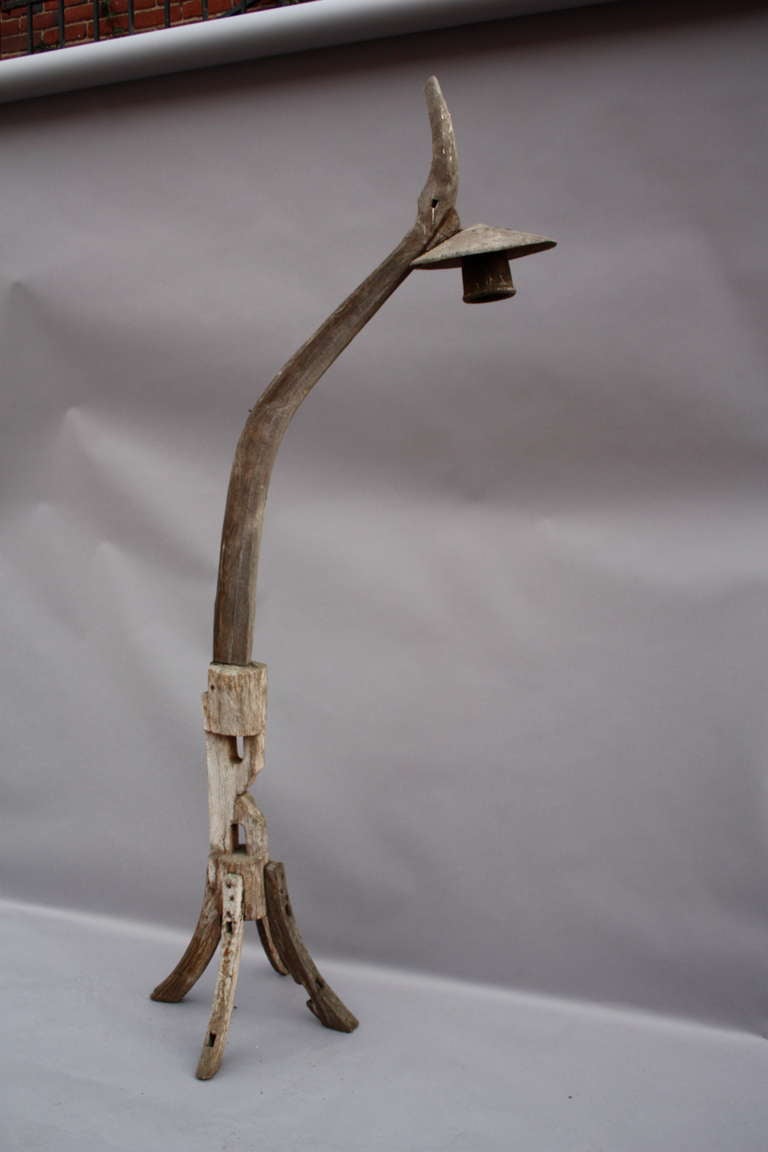 A very artistic floor lamp made of old farm implements