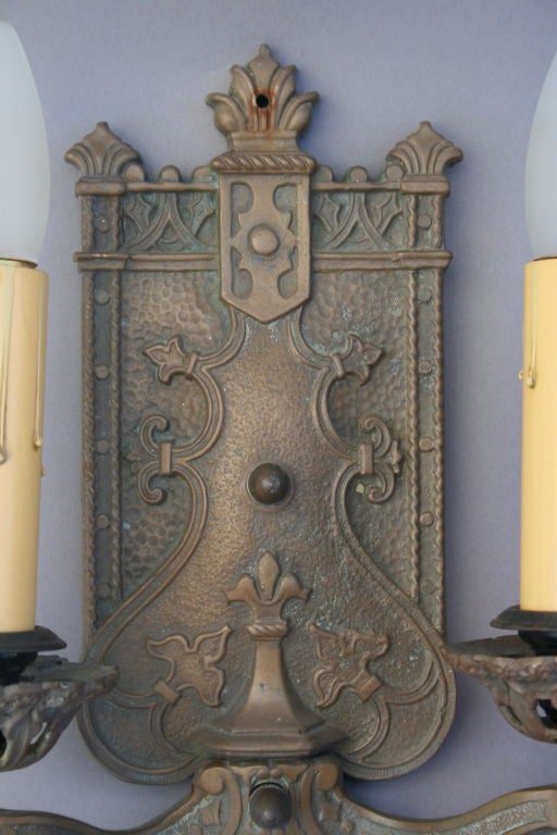 A very nice pair of Spanish Revival double light sconces with fine raised design.