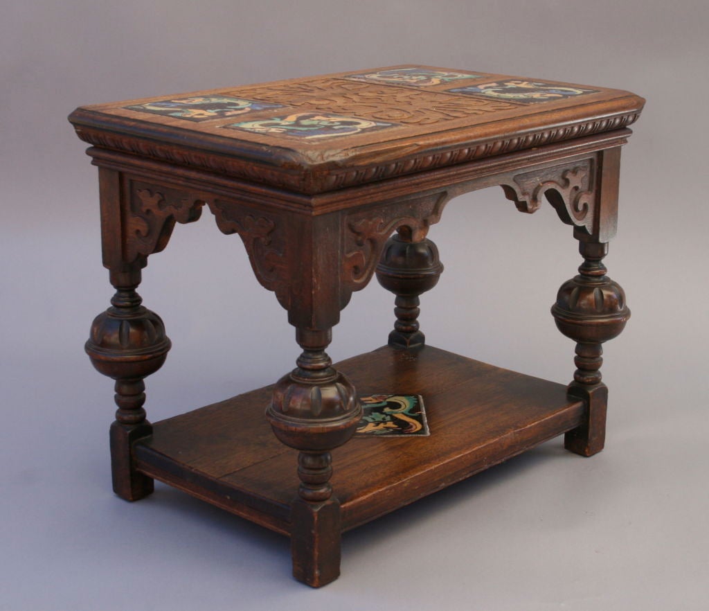 Rare carved wooden table by the Los Angeles Furniture Company set with original Tudor tiles in a gorgeous color palette
