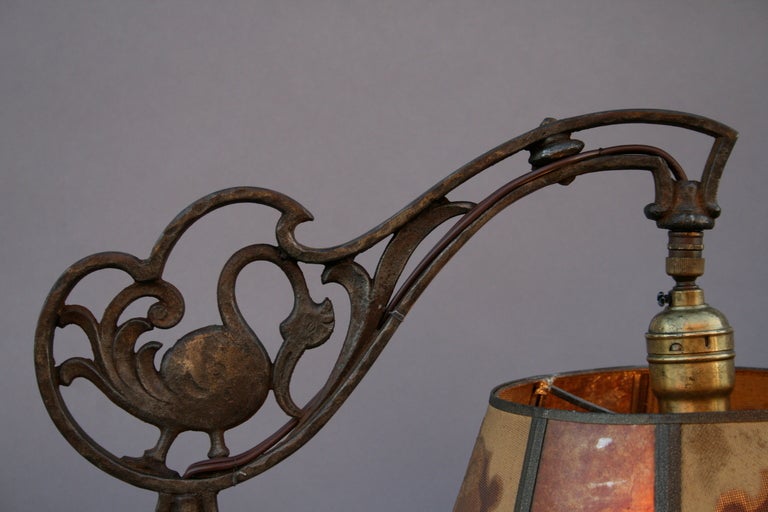 An elegant 1920's lamp with whimsical swan motif and original mica and mesh motif.