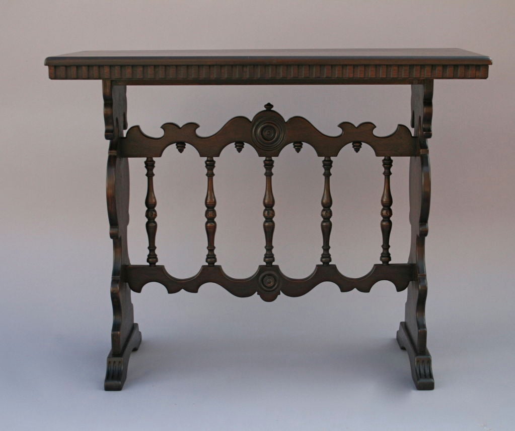 Nicely designed console table c. 1920's by Kittinger; turned spindles and concentric carving on either side are emphasized by rich, dark finish.