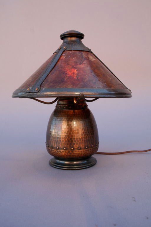 Beautiful Old Mission KopperKraft boudoir lamp. Finely hammered surface with original patina. This lamp has a riveted three-armed structure and a single-socket bulbous base and a three-panel flaring shade. Maker's mark to underside ''Old Mission