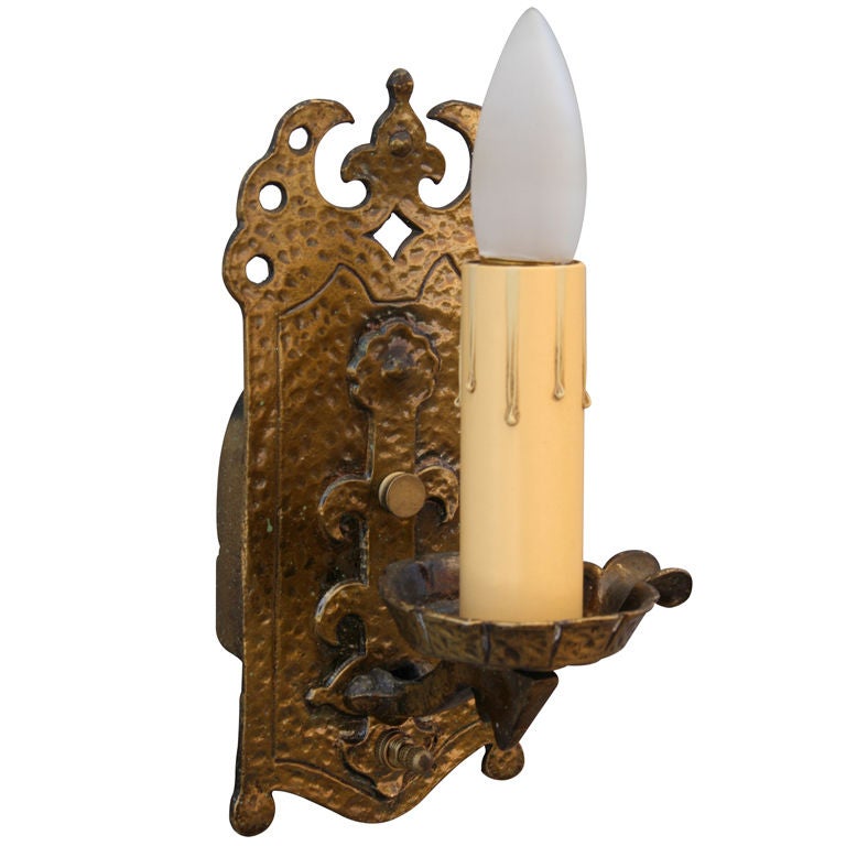 Pair of single light sconces with pierced design