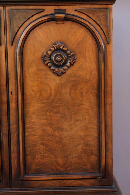 Walnut 1920's cabinet with elegant carved details.